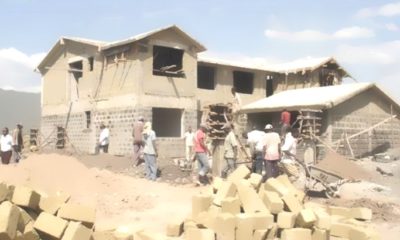 Construction workers build a house in Kisumu.