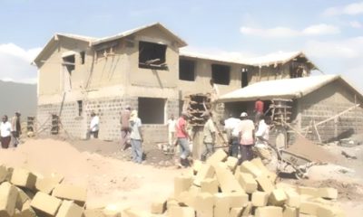 Construction workers build a house in Kisumu.