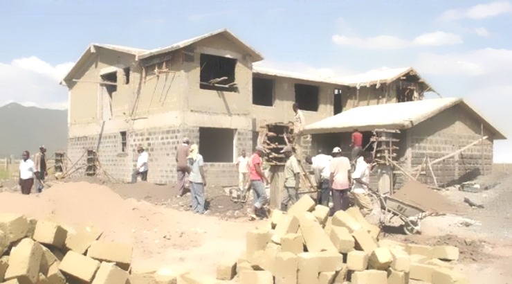 Construction workers build a house in Kisumu.