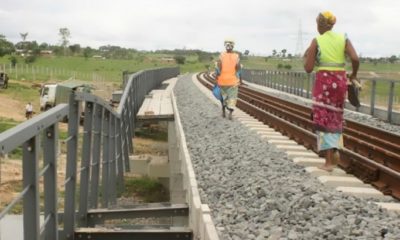 Workers pass by a vandalised section of the railway.