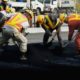 Workers pour bitumen on a road