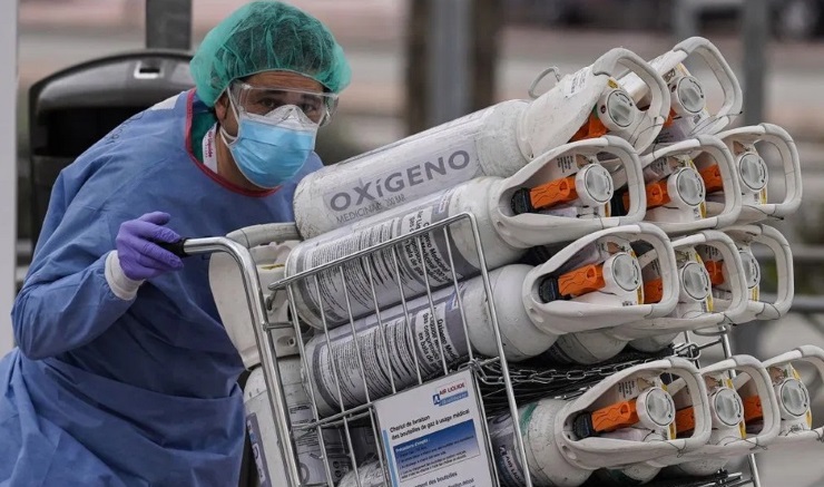 A medic moves oxygen tanks outside a hospital in Madrid.