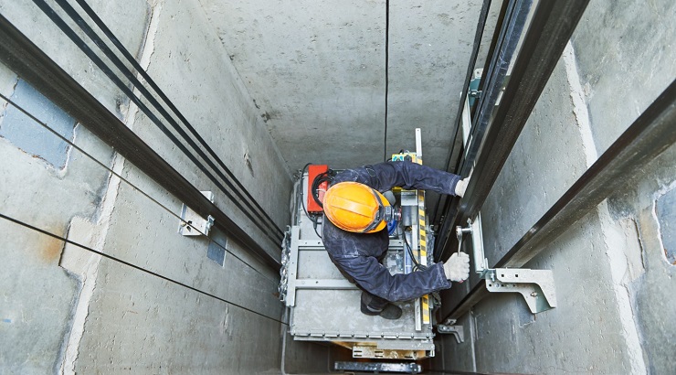 Technician repairs an elevator