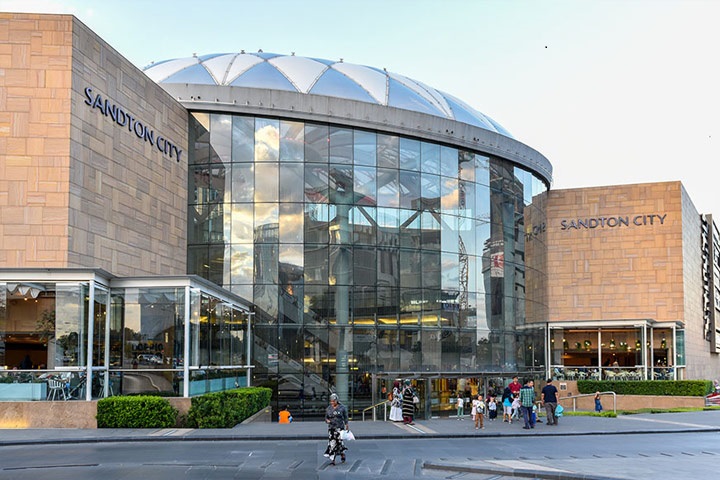 Sandton City exterior with upscale storefronts and urban surroundings.